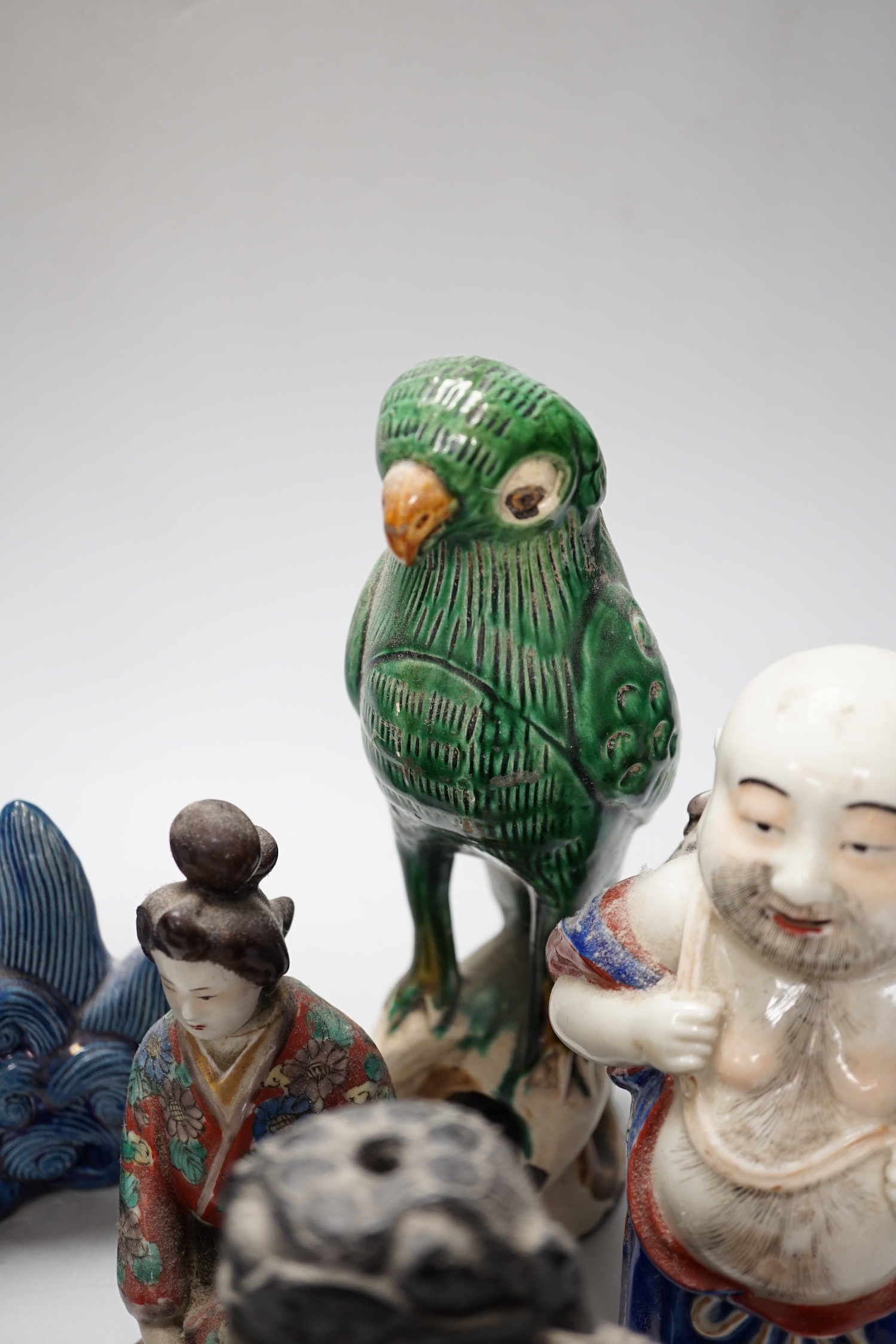 A group of assorted Chinese and Japanese pottery and porcelain figures, 19th/20th century, tallest 26cm high